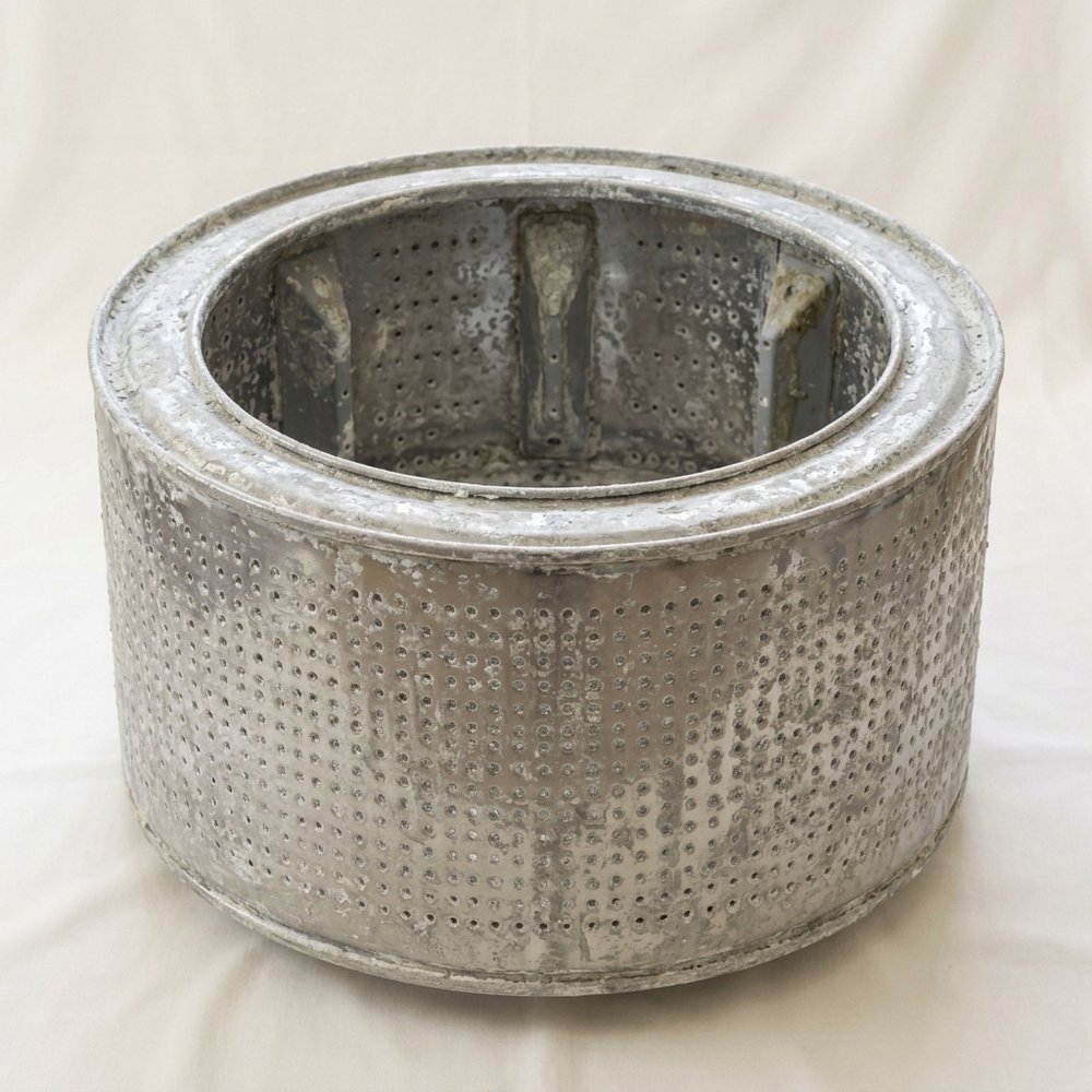 Washing machine drum scaled up with limescale before descaling